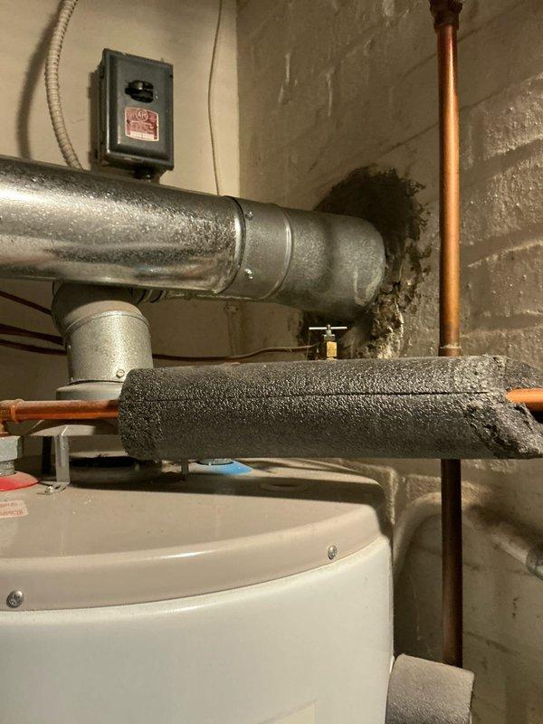 Conducted assessment of heating system for potential replacement, inspecting current Bryant furnace installation and associated ductwork in utility room. Evaluated two hot water tanks, noting one with visible insulated ventilation piping and copper supply lines. Provided customer with replacement options and complete estimate for furnace and both water heaters.