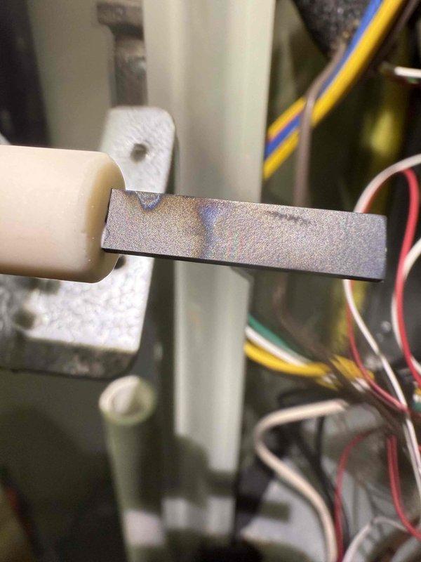 Performed heating system maintenance and combustion analysis using Bacharach gas analyzer, which confirmed system efficiency at 94.8% with CO levels at 15 ppm, O2 at 77%, and CO2 at 7.4%. Inspected flame sensor/electrode assembly and internal wiring connections, finding all components in operational condition.