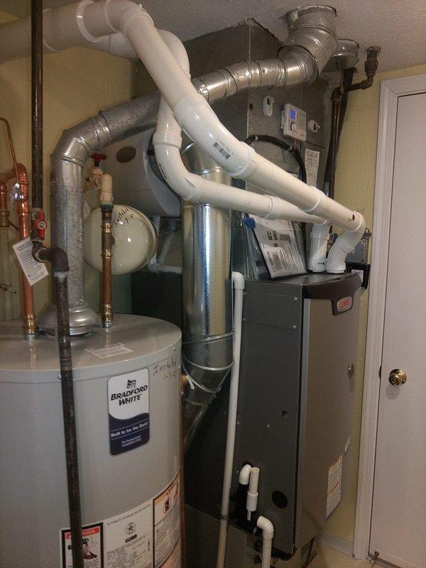 Completed humidifier installation with new plumbing connections integrated into the existing HVAC system. Installation included PVC piping with proper drainage configuration and connection to the home's water supply. System was tested and verified operational with all components properly secured.