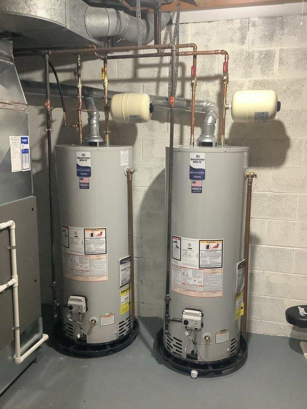 Successfully replaced two 50-gallon water heaters with new Bradford White units, each with expansion tanks, new shut-off valves, and drain pans routed to the floor drain. Upgraded the plumbing system by replacing two 1/2" stop and waste valves in the utility room ceiling with quarter-turn ball valves, and installed new quarter-turn ball valves in the copper lines serving the first floor kitchen and basement bar sinks. All installations include manufacturer's 10-year warranty on tanks.