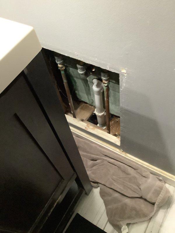 Responded to service call for dual faucet leaks. Accessed wall plumbing panel to inspect supply lines and valves for the bathroom sink and bathtub fixtures. Diagnosed and repaired leaks in both the sink's two-handle chrome faucet and bathtub faucet, restoring proper functionality to both fixtures.