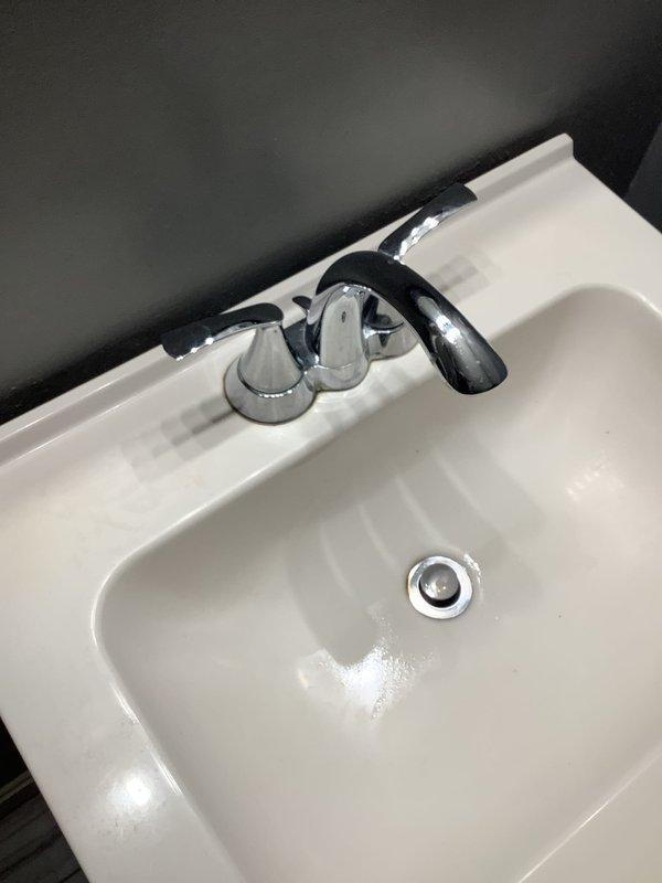 Responded to service call for dual faucet leaks. Accessed wall plumbing panel to inspect supply lines and valves for the bathroom sink and bathtub fixtures. Diagnosed and repaired leaks in both the sink's two-handle chrome faucet and bathtub faucet, restoring proper functionality to both fixtures.