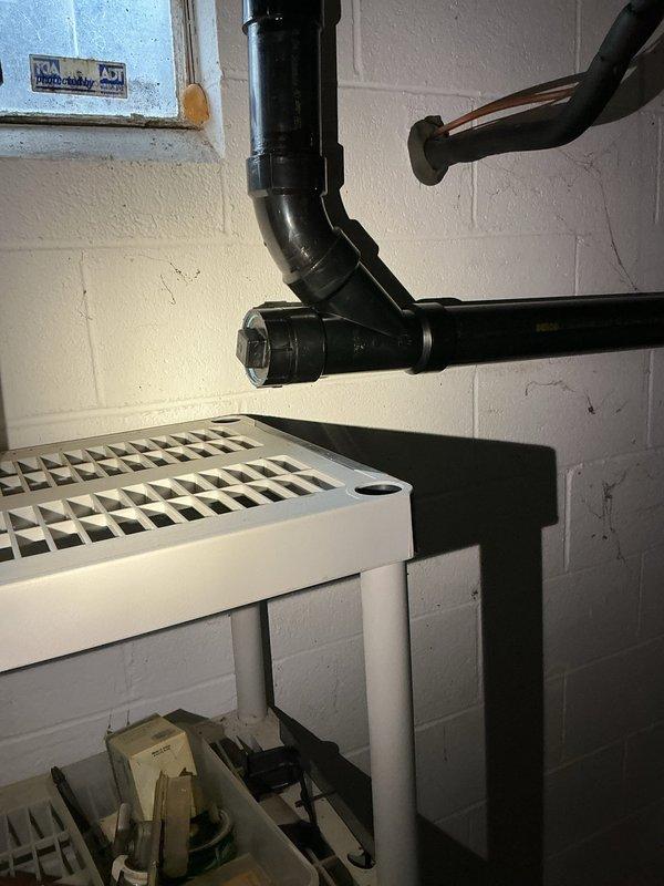 Responded to service call regarding water leakage from dishwasher and backup issues affecting toilet and shower. Inspection revealed drainage system blockage in the main waste line. Cleared obstruction and verified proper drainage function through all fixtures, with particular attention to the PVC junction connections in basement utility area.
