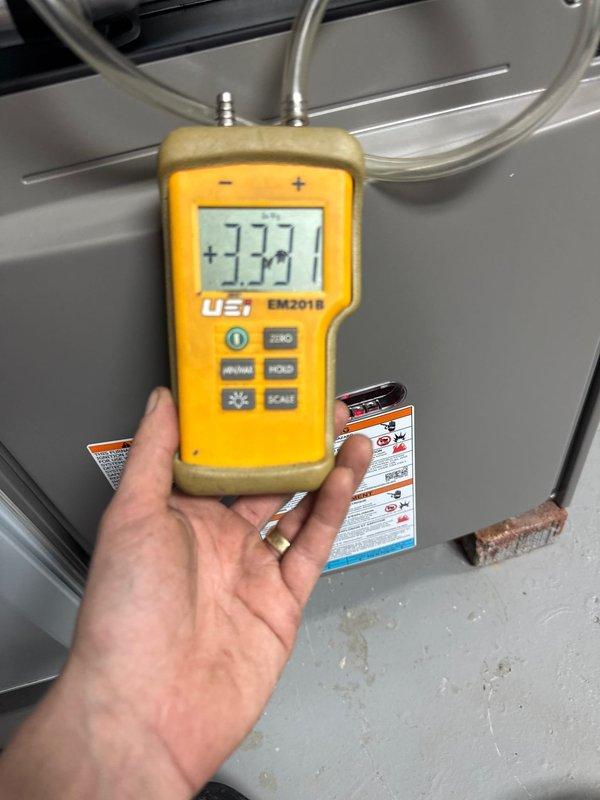Completed installation of a new high-efficiency furnace with proper PVC venting. Conducted post-installation diagnostic testing using UEi EM201B meter, confirming system pressure reading of 3.37, which is within manufacturer specifications. System was properly positioned in utility area with all connections secured and operational verification completed.