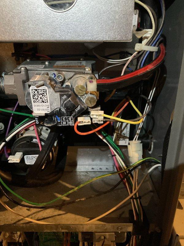 Responded to no-heat call for 5-year-old furnace. Diagnosed faulty gas valve based on visual inspection of internal components. Replaced gas valve assembly, reconnected all associated wiring (red, yellow, green, blue, white, and orange), and verified proper operation of the unit. System now functioning normally.