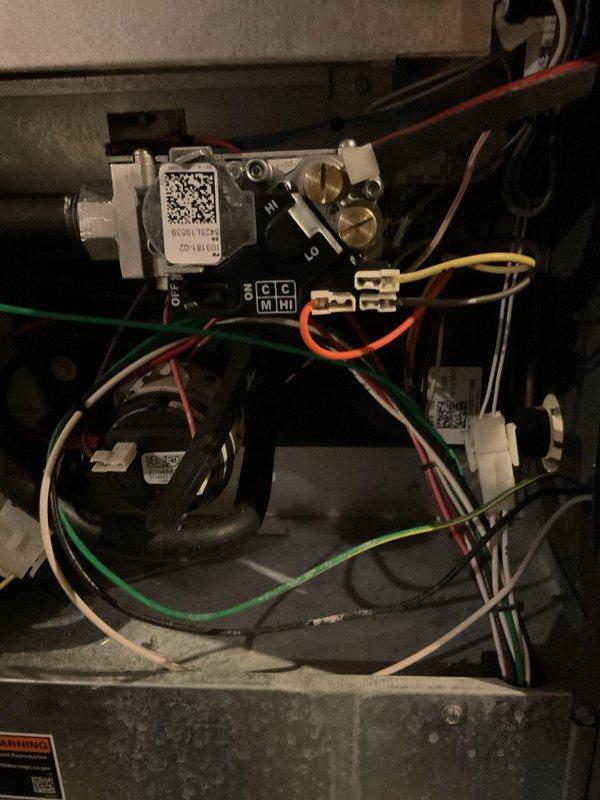 Responded to no-heat call for 5-year-old furnace. Diagnosed faulty gas valve based on visual inspection of internal components. Replaced gas valve assembly, reconnected all associated wiring (red, yellow, green, blue, white, and orange), and verified proper operation of the unit. System now functioning normally.
