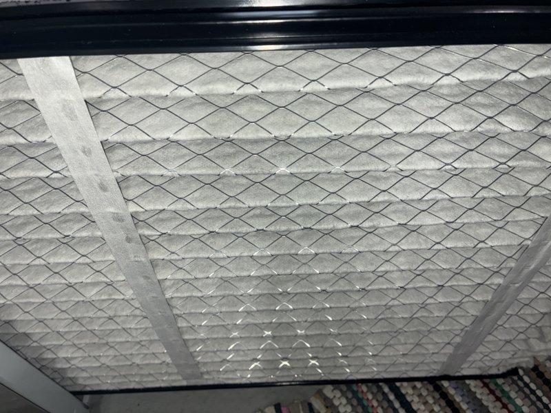 Completed scheduled maintenance on 8-year-old furnace. Inspected and documented condition of air filter, which showed normal usage wear with some particle accumulation in the filtration media. Filter housing and mounting system appear to be functioning properly with no issues noted.