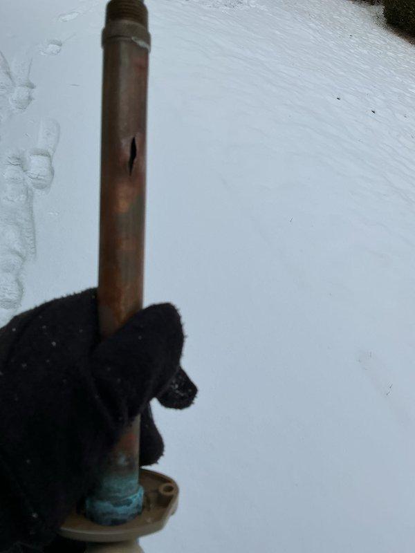 Responded to emergency call for burst copper pipe in 40-year-old home. Upon inspection, identified longitudinal split in aging copper supply line with significant corrosion at fitting connection. Removed damaged ceiling tiles to access affected area, cut out compromised pipe section, and installed new copper pipe segment with appropriate brass fittings to restore water service.
