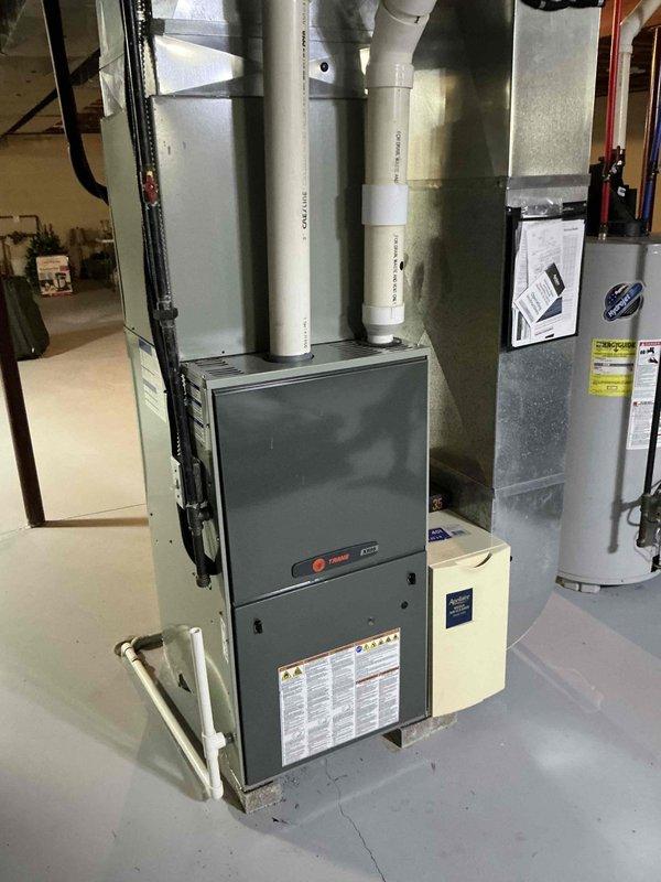 Conducted furnace inspection and identified critical heat exchanger crack in existing Trane unit. Recommended complete system replacement due to safety concerns and potential carbon monoxide risks. Documented current installation configuration for proper replacement specifications.
