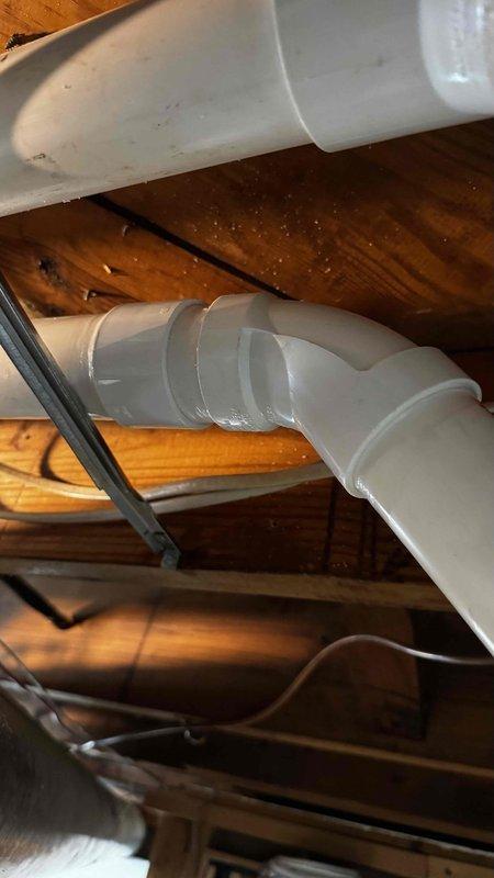 Replaced leaking three-quarter inch PVC condensate drain line and installed two 45-degree elbows on exhaust piping that were previously causing water leakage. Verified proper drainage function and secure connections after installation to ensure system operates correctly without water discharge onto floor.