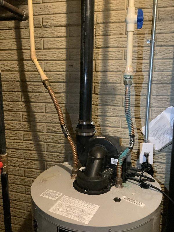 Inspected customer's hot water tank due to inadequate heating performance. Visual examination of the tank and plumbing connections revealed no external leaks or damage to the unit or associated piping. Confirmed proper installation of exhaust ventilation and supply lines, with all valves and connections appearing intact and functional.