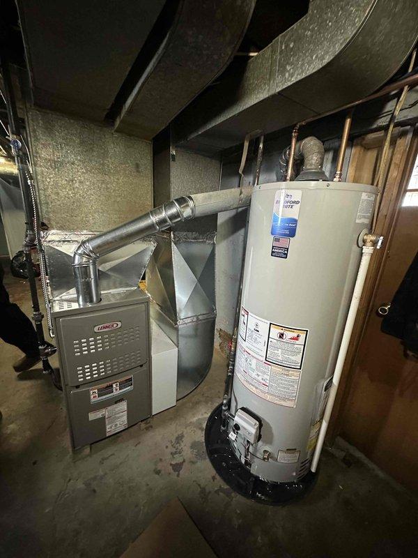 Completed installation of Lennox gas furnace system with connection to existing ductwork in residential basement mechanical room. Installed new 80 HWT water heater with proper copper pipe connections and shutoff valves. All systems tested and confirmed to be in proper working condition.