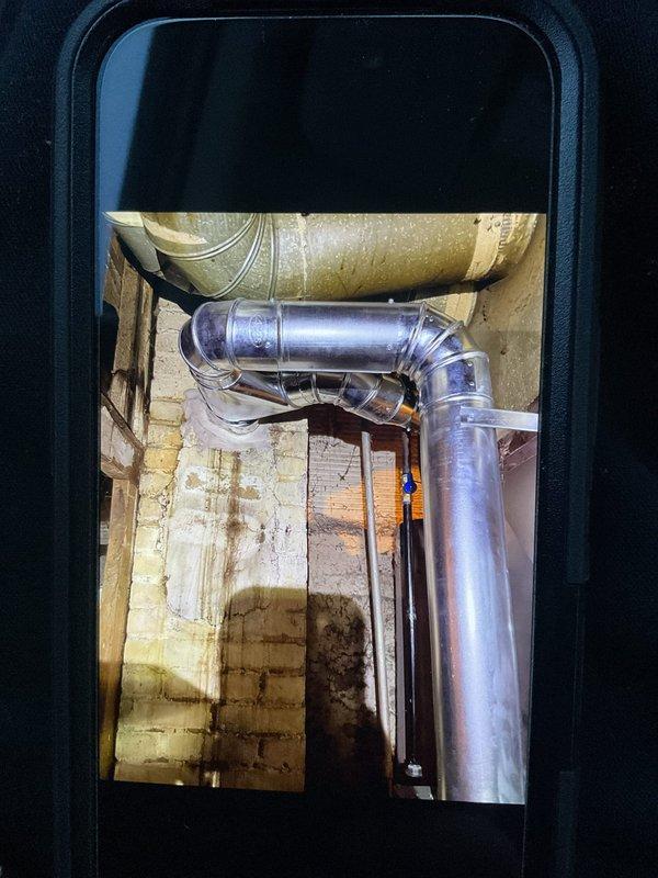 Connected furnace and water heater flues per customer request and performed startup procedures. Used UEi EMT20 test instrument to take diagnostic readings on the system. Inspected ductwork installation including the 90-degree elbow joint, noting some moisture signs on adjacent wall that customer should monitor.