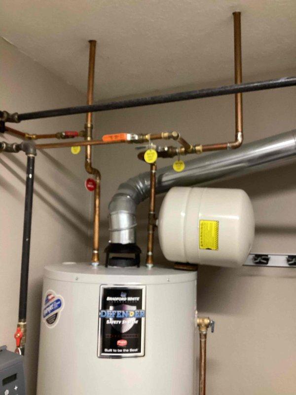 Performed scheduled maintenance visit on Lennox SL280DF070V36A-05 heating system. Confirmed with customer that cooling service is no longer required and will be honored in 2026 as per MVP agreement. Inspected gas connections and water heater installation for safety compliance, documenting equipment condition with photographs.