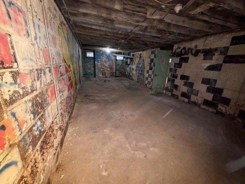 Conducted site assessment of gutted home requiring complete HVAC replacement. Basement inspection revealed significant deterioration with exposed structural elements, damaged concrete flooring, and compromised plumbing system. Noted existing drainage assembly with PVC piping that will need to be integrated with new HVAC installation during upcoming renovation project.