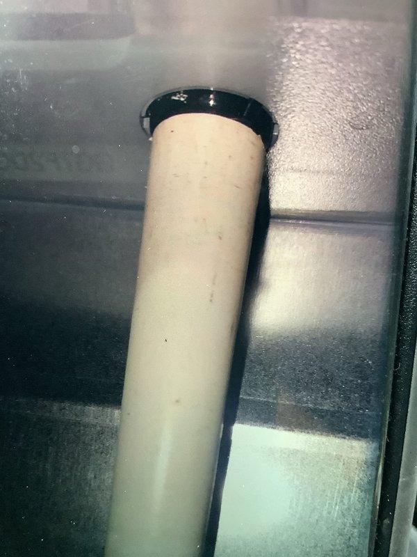 Responded to service call for leaking humidifier. Discovered water pooling on floor due to disconnected PVC drain line. Inspected and reattached drain pipe, securing connection points. Also noted significant dust accumulation on air filter requiring replacement to maintain proper system operation and indoor air quality.