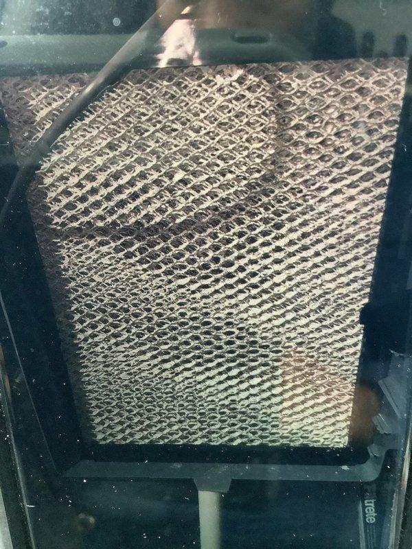 Responded to service call for leaking humidifier. Discovered water pooling on floor due to disconnected PVC drain line. Inspected and reattached drain pipe, securing connection points. Also noted significant dust accumulation on air filter requiring replacement to maintain proper system operation and indoor air quality.