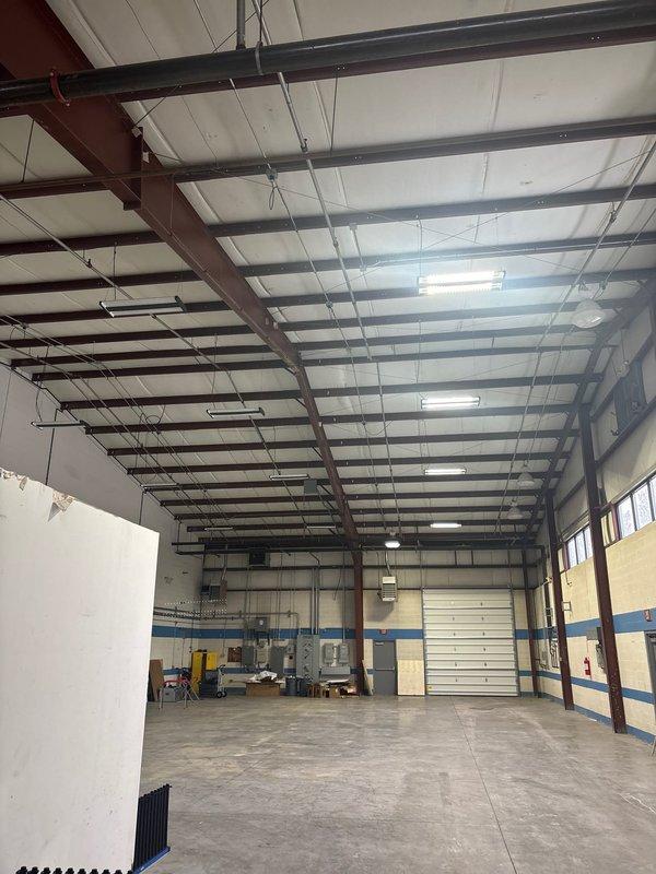 Installed electrical power supply to customer's newly installed garage door in industrial warehouse space. Connected power from existing nearby electrical source to the garage door operator, ensuring proper function and code compliance.