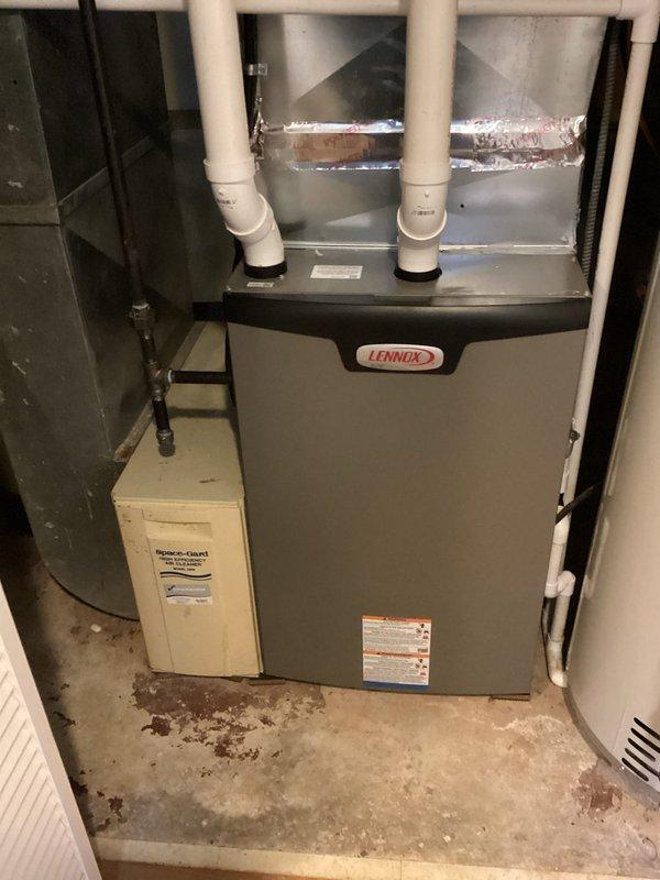 Performed annual maintenance check on 12-year-old Amana furnace system (MVP: 2024). Inspected Lennox furnace unit including PVC ventilation pipes, ductwork, and attached humidifier system. Examined air filter which showed significant dust accumulation and discoloration requiring replacement. System confirmed operational with no issues detected.