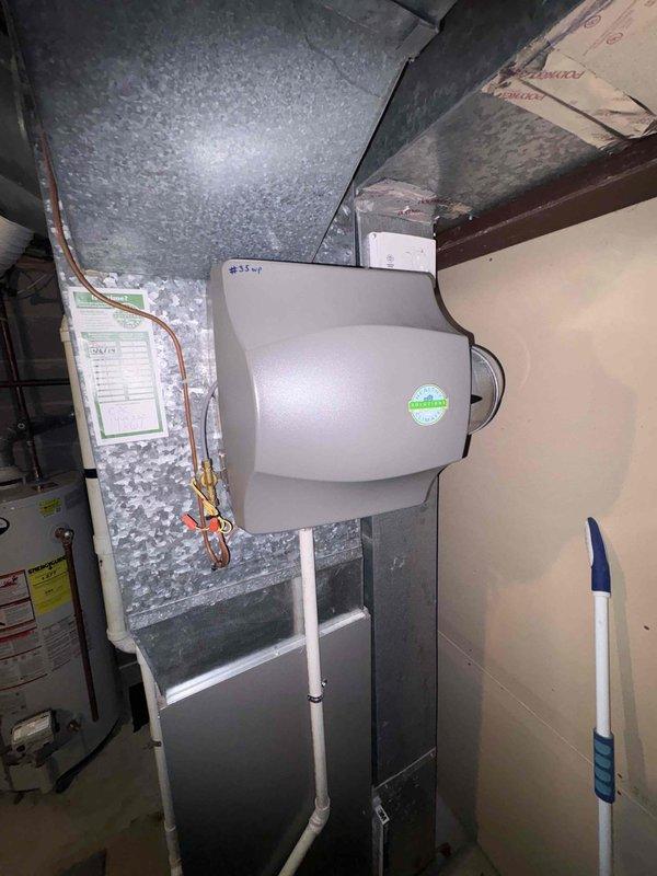 Completed estimate for replacement of 15-year-old furnace system including options for air cleaner and humidifier installation. Assessed existing ductwork configuration and measured system dimensions to ensure proper equipment sizing. Customer considering package upgrade with humidifier mounted on metal ductwork connected to PVC piping.