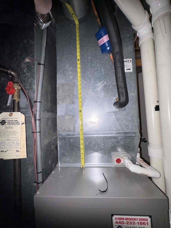 Completed estimate for replacement of 15-year-old furnace system including options for air cleaner and humidifier installation. Assessed existing ductwork configuration and measured system dimensions to ensure proper equipment sizing. Customer considering package upgrade with humidifier mounted on metal ductwork connected to PVC piping.