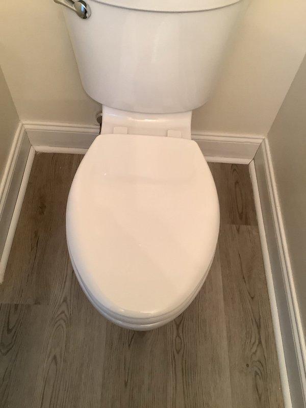 Successfully replaced first floor half bath toilet with new American Standard Champion model featuring right height bowl, elongated design, and slow-close seat. Installed new angle stop and escutcheon, and connected with new braided supply line. All connections tested and verified to be leak-free.