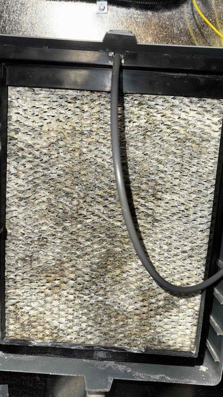 Performed scheduled maintenance on 12-year-old furnace. Replaced heavily soiled air filter. Identified and documented structural crack with oxidation, marked with yellow indicator for future reference.