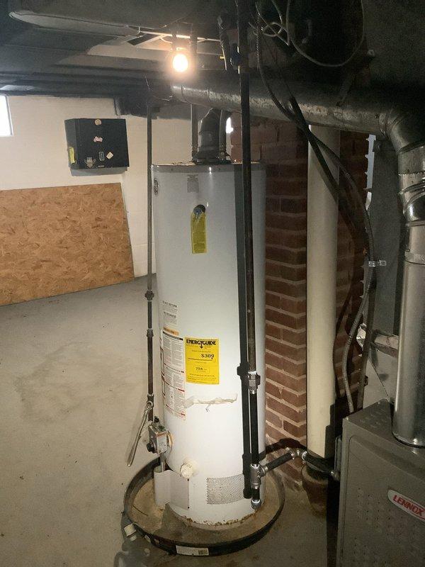 Replaced existing GE water heater in basement mechanical room. Installed new unit on drain pan, connected water lines, and properly vented according to manufacturer specifications. Verified all connections were secure and system was functioning correctly before departure.