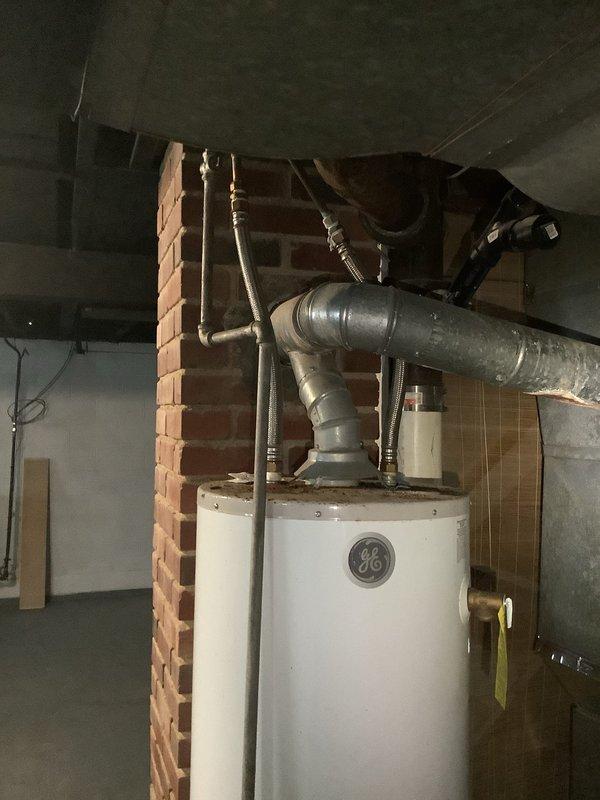 Replaced existing GE water heater in basement mechanical room. Installed new unit on drain pan, connected water lines, and properly vented according to manufacturer specifications. Verified all connections were secure and system was functioning correctly before departure.