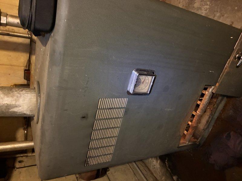 Responded to emergency service call for active leak in aging boiler system. Upon inspection, identified significant corrosion on pressure gauge assembly and surrounding fittings. Replaced damaged components, pressure tested system, and verified proper operation of heating unit.