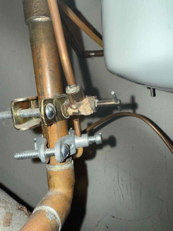 Performed tune-up on 23-year-old furnace system. Inspected copper piping connections and mounting brackets, noting normal aging but functional condition. Examined ventilation grille showing dust accumulation and minor corrosion; diagnosed fan noise issue likely related to the ventilation system.