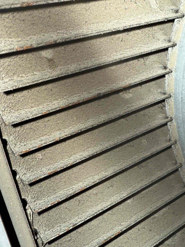 Performed tune-up on 23-year-old furnace system. Inspected copper piping connections and mounting brackets, noting normal aging but functional condition. Examined ventilation grille showing dust accumulation and minor corrosion; diagnosed fan noise issue likely related to the ventilation system.
