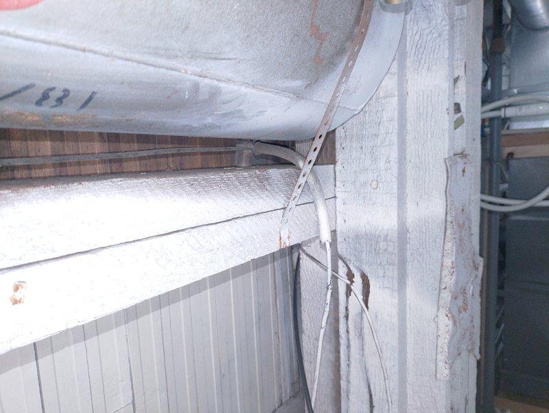 Responded to service call regarding improperly secured wiring in basement. Upon inspection, found exposed cables running along utility walls without proper fastening or protection. Secured all hanging wires with appropriate brackets, ensured proper wire routing along structural elements, and verified all connections were safely terminated. Documented completed work with photos for client verification.