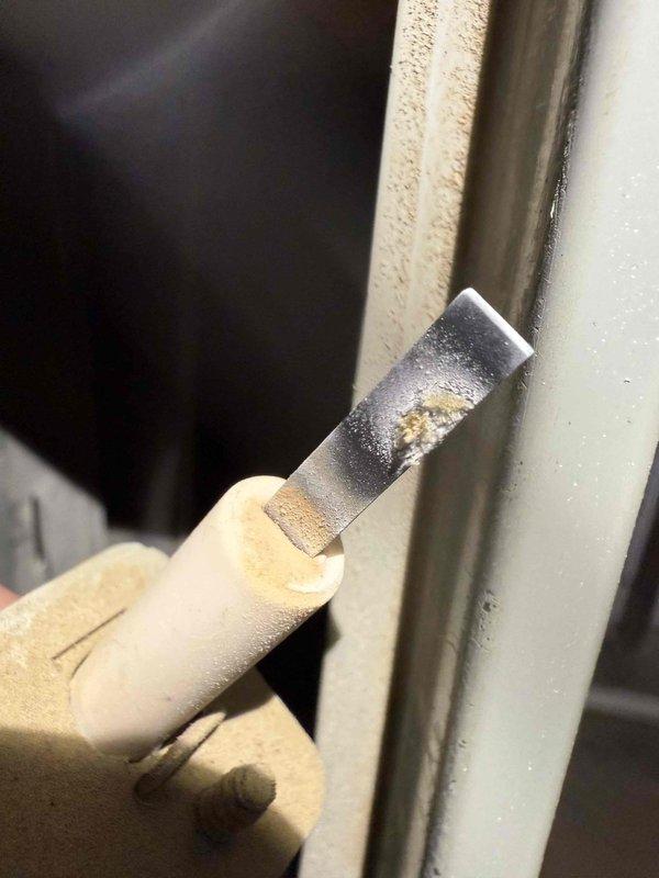 Performed routine furnace maintenance including inspection of the White-Rodgers control board and ICM 280C module. Cleaned accumulated dust and debris from circuit board and checked all electrical connections. Scraped away residue from equipment frame to ensure proper sealing and operation.