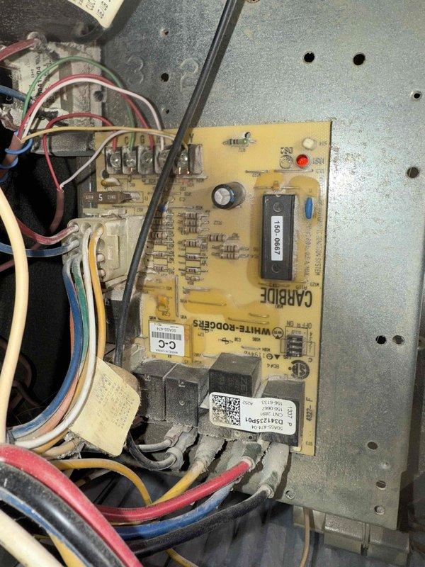 Performed routine furnace maintenance including inspection of the White-Rodgers control board and ICM 280C module. Cleaned accumulated dust and debris from circuit board and checked all electrical connections. Scraped away residue from equipment frame to ensure proper sealing and operation.