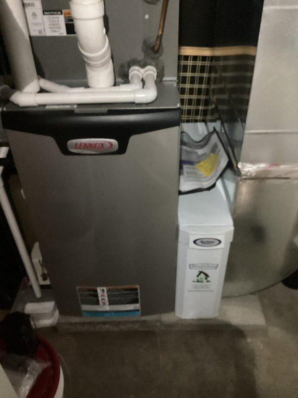 Performed scheduled maintenance service on Lennox heating system with Aprilaire humidifier for MVP customer. Inspected heat exchanger and evaporator coil, which were found to be in normal working condition with no visible issues. System is functioning properly with all components correctly connected.