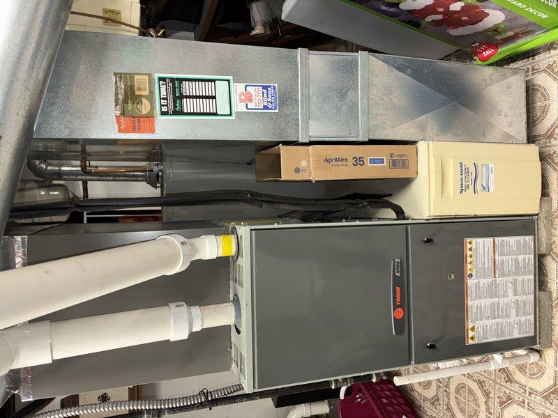Performed annual furnace maintenance on 9-year-old Trane system with MVP expiring in 2024. Inspected furnace components and exhaust/intake PVC piping. Found heavily clogged air filter with significant dust buildup and possible mold accumulation; replaced with new AprilAire 35 filter to improve system efficiency and air quality.
