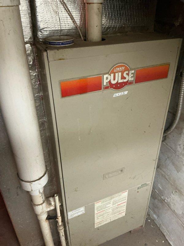 Conducted evaluation of 37-year-old Lennox PULSE furnace in basement for potential replacement. System shows significant age-related wear with compromised ductwork connections. Basement has DIY foil-faced insulation panels installed throughout. Recommended full system replacement due to equipment age, efficiency concerns, and potential safety issues with this older pulse combustion model.