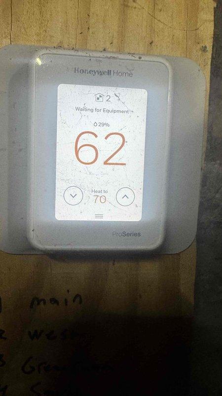 Performed comprehensive tune-up on dual system setup (heat pump and gas boiler) with zoning controls. Inspected Honeywell ProSeries thermostat functionality, confirming proper operation with heat setpoint at 70°F. Conducted diagnostic testing on gas valve assembly using Fieldpiece meter, checked all electrical connections, and verified proper burner operation in the gas boiler.