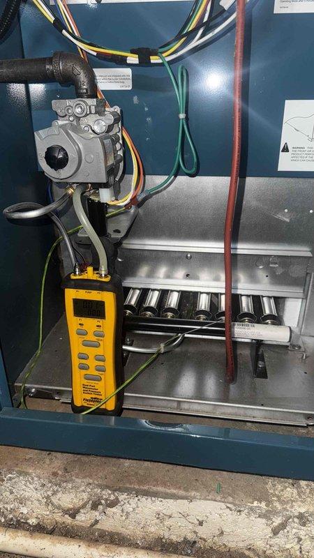 Performed comprehensive tune-up on dual system setup (heat pump and gas boiler) with zoning controls. Inspected Honeywell ProSeries thermostat functionality, confirming proper operation with heat setpoint at 70°F. Conducted diagnostic testing on gas valve assembly using Fieldpiece meter, checked all electrical connections, and verified proper burner operation in the gas boiler.