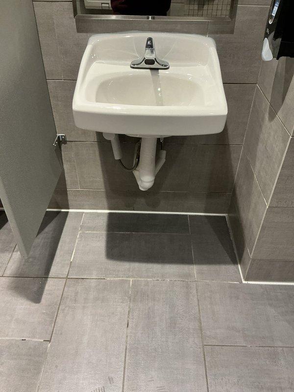 Responded to service call regarding urinal flooding after multiple flushes. Upon inspection of the commercial restroom, identified drainage issue in wall-mounted urinal with chrome flush valve. Cleared blockage in drain line to restore proper drainage function and prevent future flooding incidents.