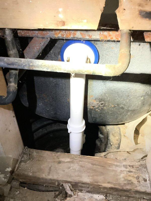 Completed waste and overflow replacement on basement shower. Opened wall behind shower to access plumbing. Removed old rusted drain assembly and installed new PVC waste line with proper connections to existing plumbing system. Verified proper drainage function after installation.