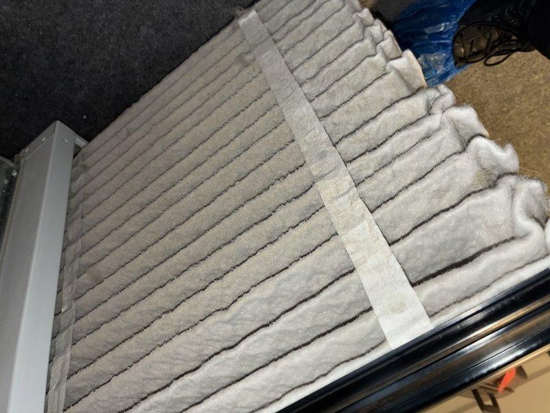 Performed routine maintenance on 12-year-old heating system. Inspected and documented condition of air filter showing moderate dust accumulation. Examined copper refrigerant line for proper installation and condition.