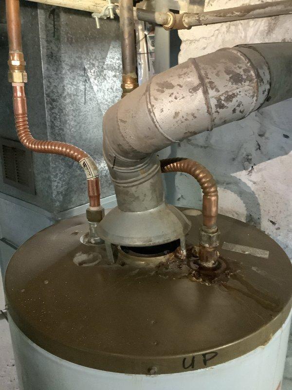 Responded to service call for leaking water heater with insufficient hot water. Diagnosed 16-year-old unit (installed 02-04-07) with significant corrosion at connection points and expired warranty. Replaced tank, fittings, and connected new unit to existing copper piping system.