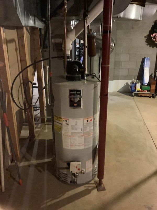 Completed installation of a Trane furnace system with PVC intake/exhaust venting in basement utility area, including conversion from natural gas to propane. Also installed a 90-gallon power-vent hot water tank with propane configuration. All connections properly secured and system tested for proper operation.