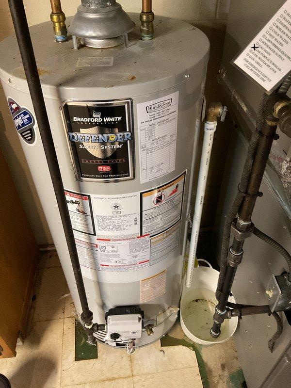 Responded to service call for leaking Bradford White water heater with no hot water output. Upon inspection, found water damage at base of unit and on adjacent wall. Determined tank failure required complete replacement. Installed new water heater with updated copper connections and verified proper operation of valves and safety systems. Customer was provided information about the new unit's warranty and operation.