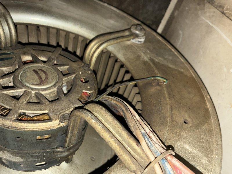 Completed scheduled maintenance visit on 20-year-old heating system. Inspected blower motor assembly which showed signs of normal operational wear. Examined and cleaned ventilation components including access panel. System functioning adequately despite age, recommended continued regular maintenance.