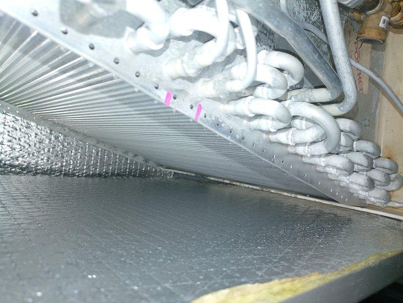 Conducted scheduled MVP Heating Visit on equipment showing significant frost accumulation on refrigerant lines and evaporator coil assembly. Inspection revealed restricted airflow through the cooling coil with ice buildup on the heat exchanger fins. Performed defrost cycle and verified proper operation of copper refrigerant lines and connections within the insulated enclosure.