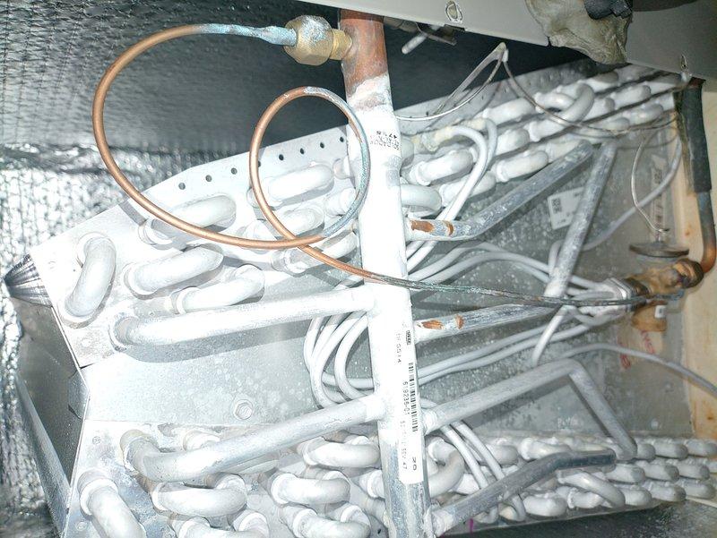 Conducted scheduled MVP Heating Visit on equipment showing significant frost accumulation on refrigerant lines and evaporator coil assembly. Inspection revealed restricted airflow through the cooling coil with ice buildup on the heat exchanger fins. Performed defrost cycle and verified proper operation of copper refrigerant lines and connections within the insulated enclosure.