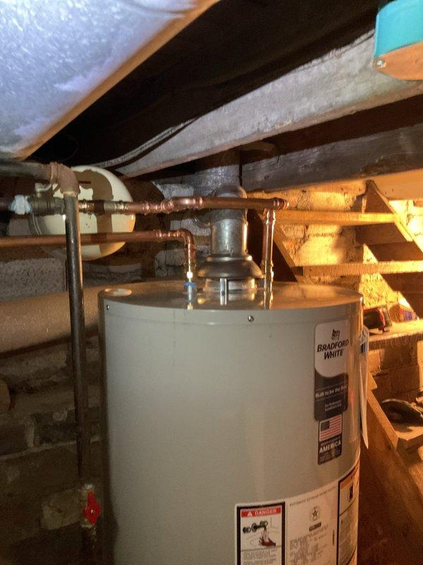 Successfully replaced a leaking 2017 30-gallon gas water heater with a new Bradford White 40-gallon short model featuring a 6-year manufacturer warranty. Installation included new ball valve, thermal expansion tank, gas shut-off valve, copper drip leg, and conversion from flexible water lines to hard-piped connections, along with removal of corroded secondary shut-off valve on hot water vertical line with complete rebuild from that point.